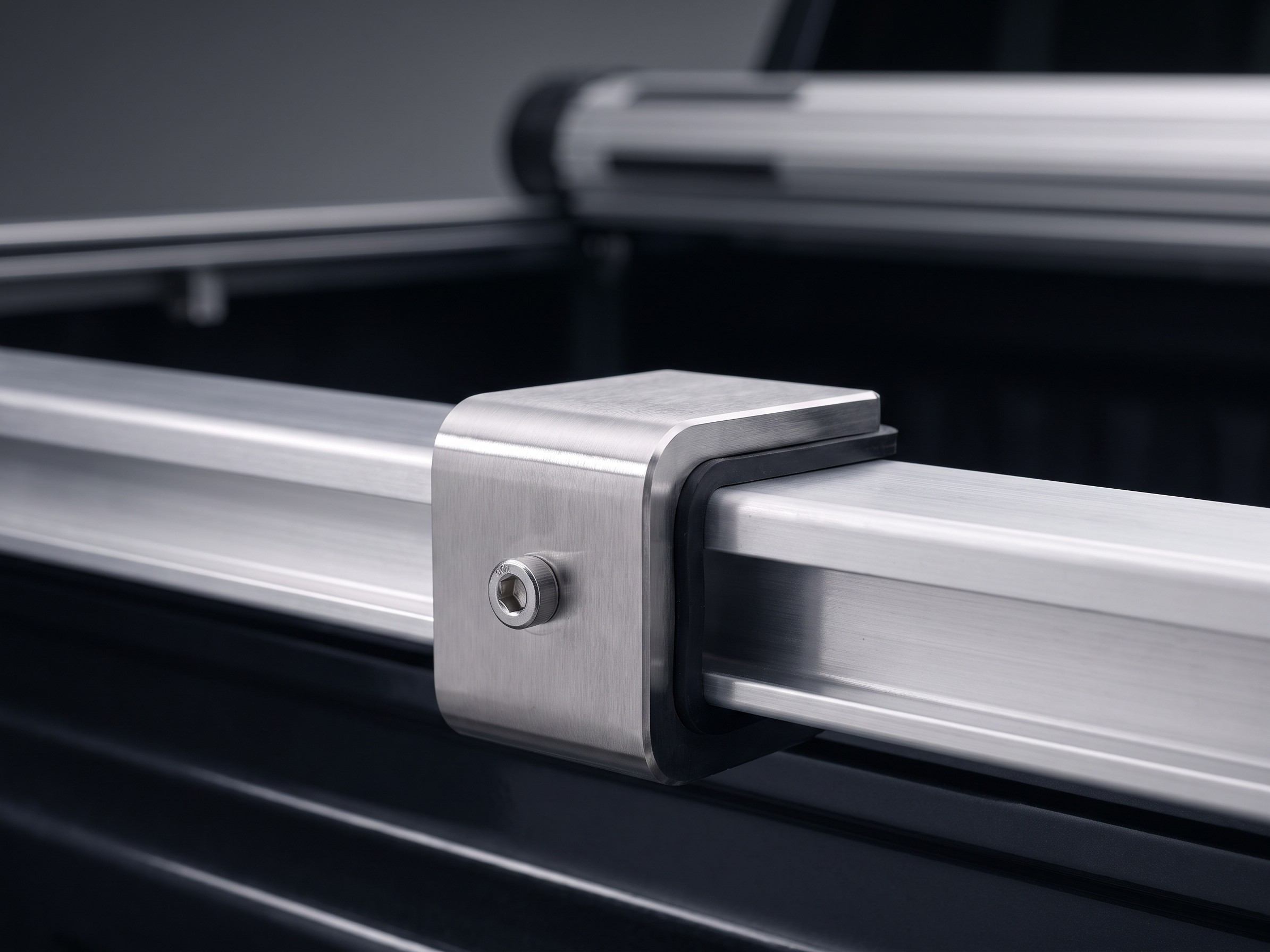 Close-up of a marine-grade stainless steel mounting bracket used to secure the Coverjet tonneau cover to the truck bed rail